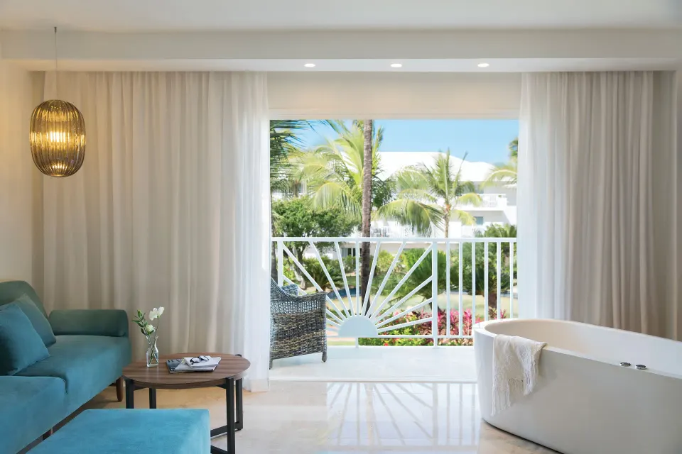 Junior Suite Garden or Mountain View sitting area and balcony at Excellence Punta Cana.