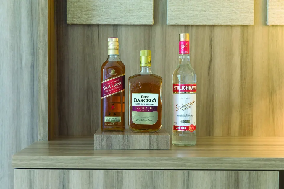 Junior Suite Garden or Mountain View liquor bottles on a shelf at Excellence Punta Cana.