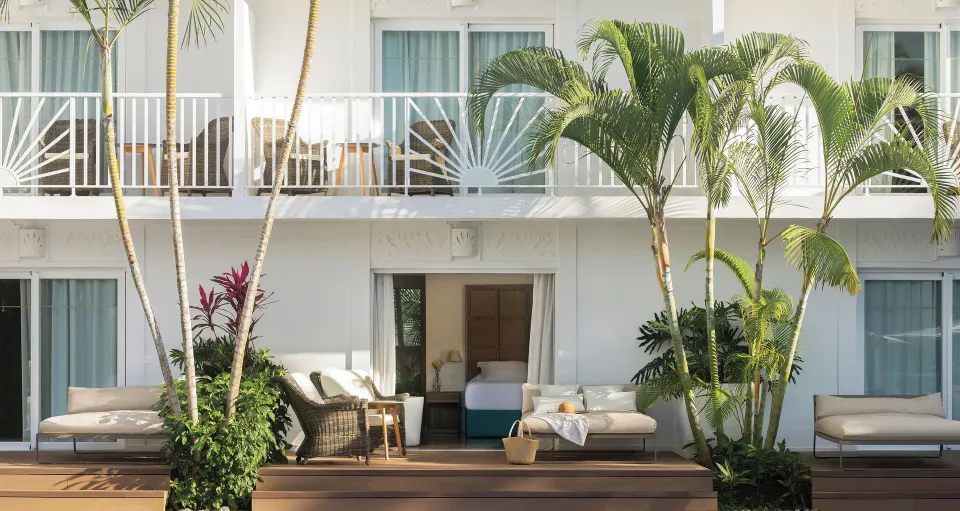 Junior Swim Up Suite terrace with lounge chairs and visible bed at Excellence Punta Cana.