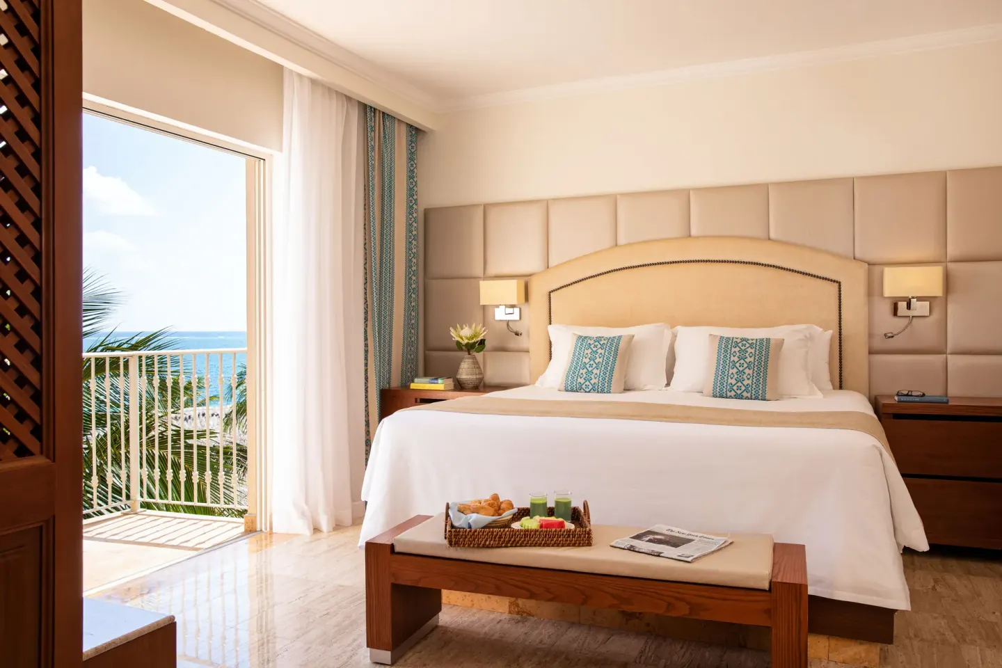 King-bed guest room with balcony and ocean view at Excellence Riviera Cancun.