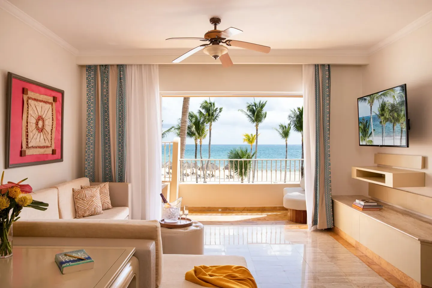 Guest room sitting area with balcony facing the beach at Excellence Riviera Cancun.