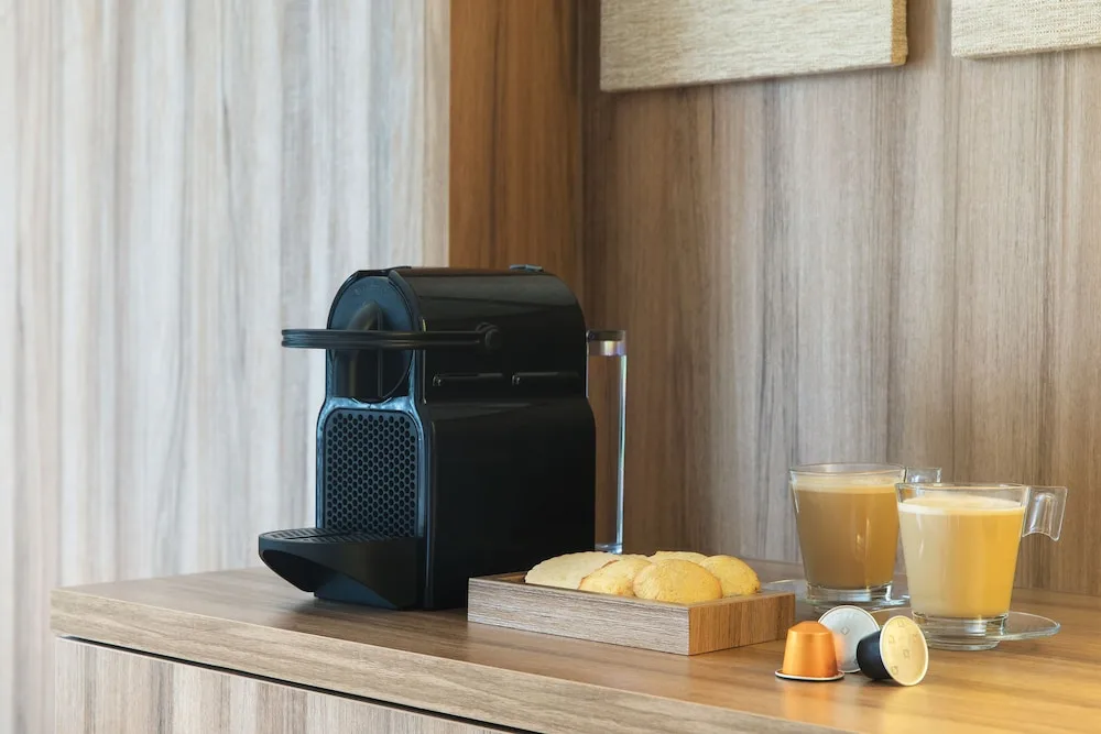 In-room coffee maker with cookies and drinks at Excellence Riviera Cancun.