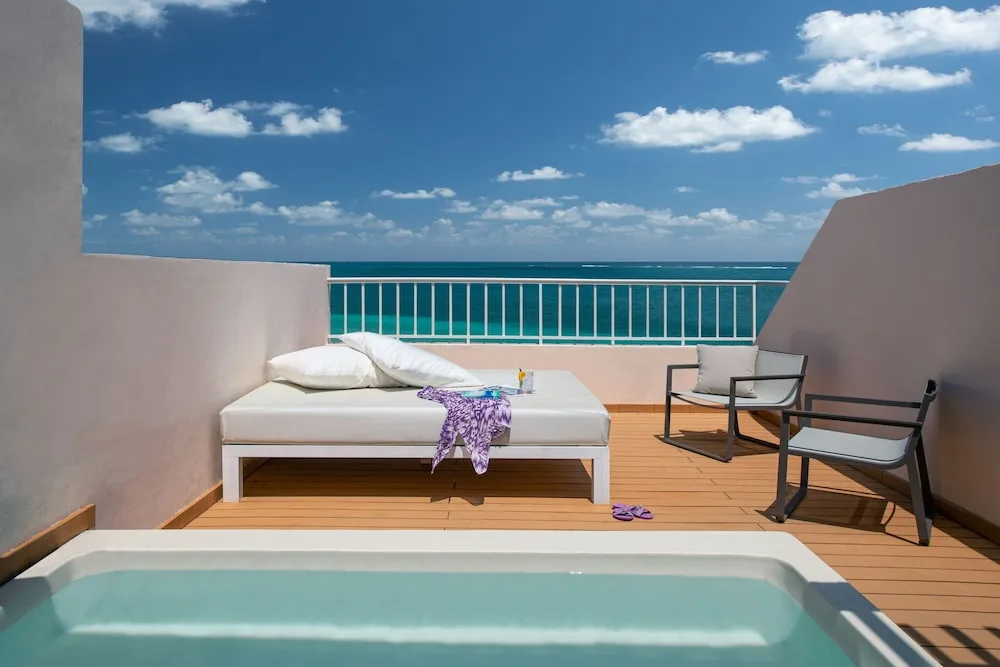 Oceanfront terrace with plunge pool and daybed at Excellence Riviera Cancun.