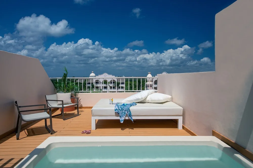 Private terrace plunge pool with daybed and lounge chair at Excellence Riviera Cancun.
