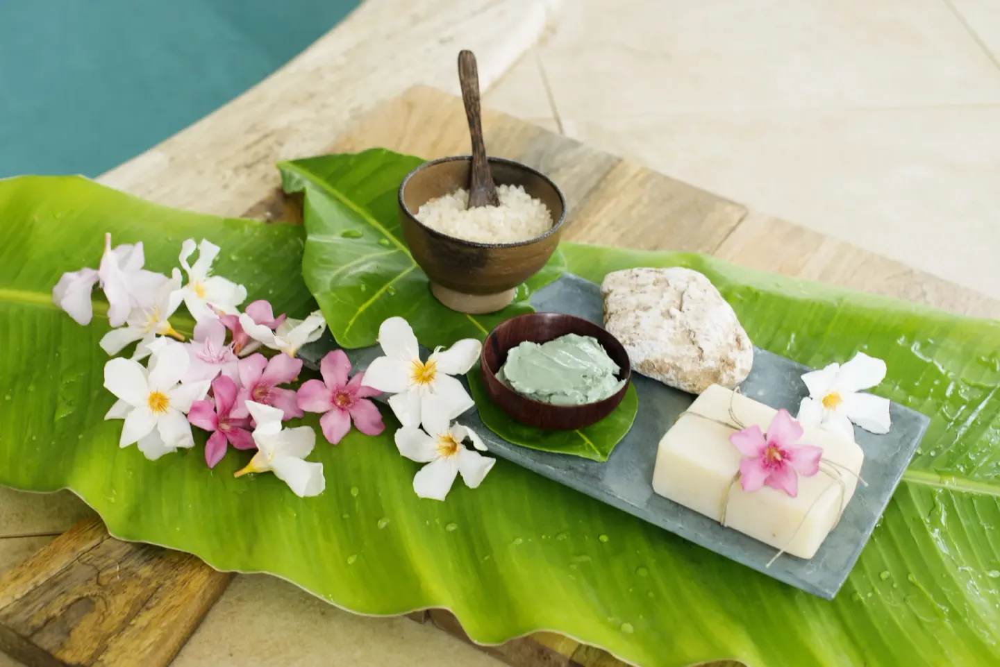 Spa ingredients with flowers on banana leaves at Excellence Riviera Cancun.