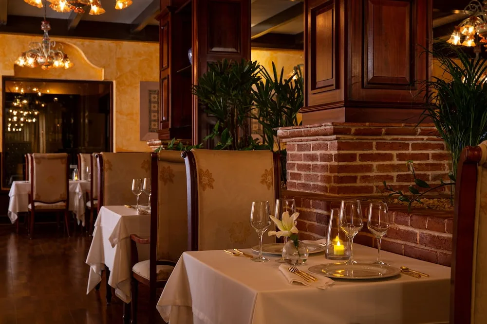 Elegant restaurant table settings with warm lighting at Excellence Riviera Cancun.
