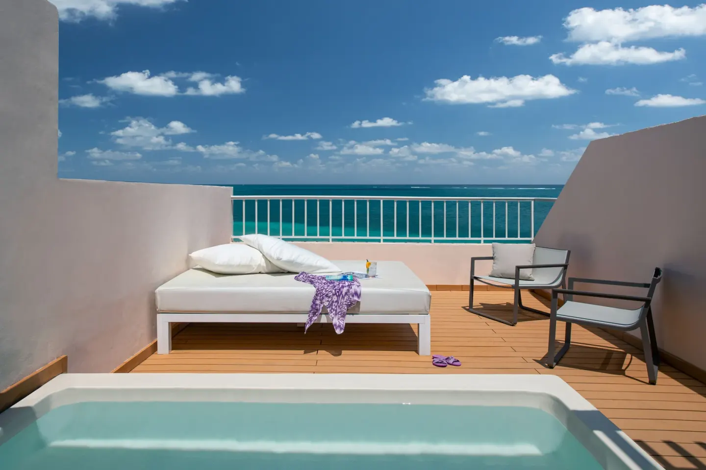 Oceanfront rooftop terrace at Excellence Riviera Cancun with plunge pool, daybed and sea view.