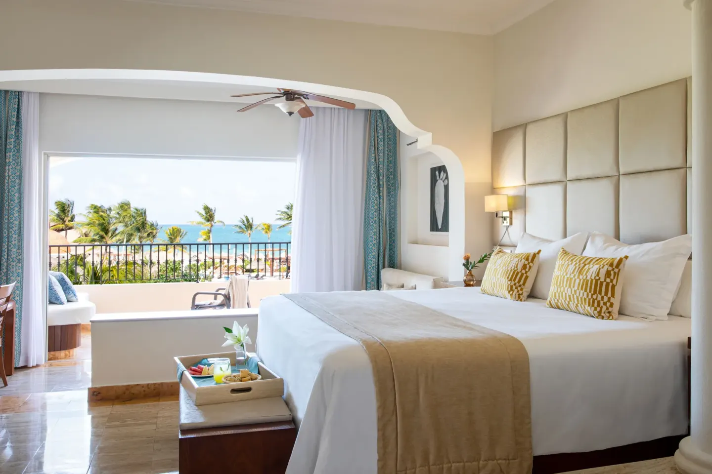Junior Suite Ocean View bedroom with king bed and balcony at Excellence Riviera Cancun.