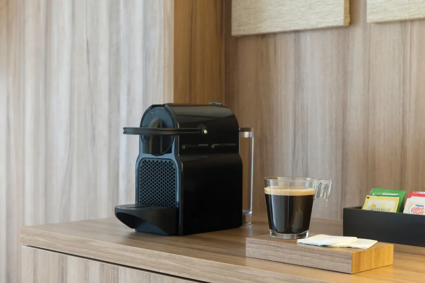 In-room coffee maker with a cup of coffee in a suite at Excellence Riviera Cancun.