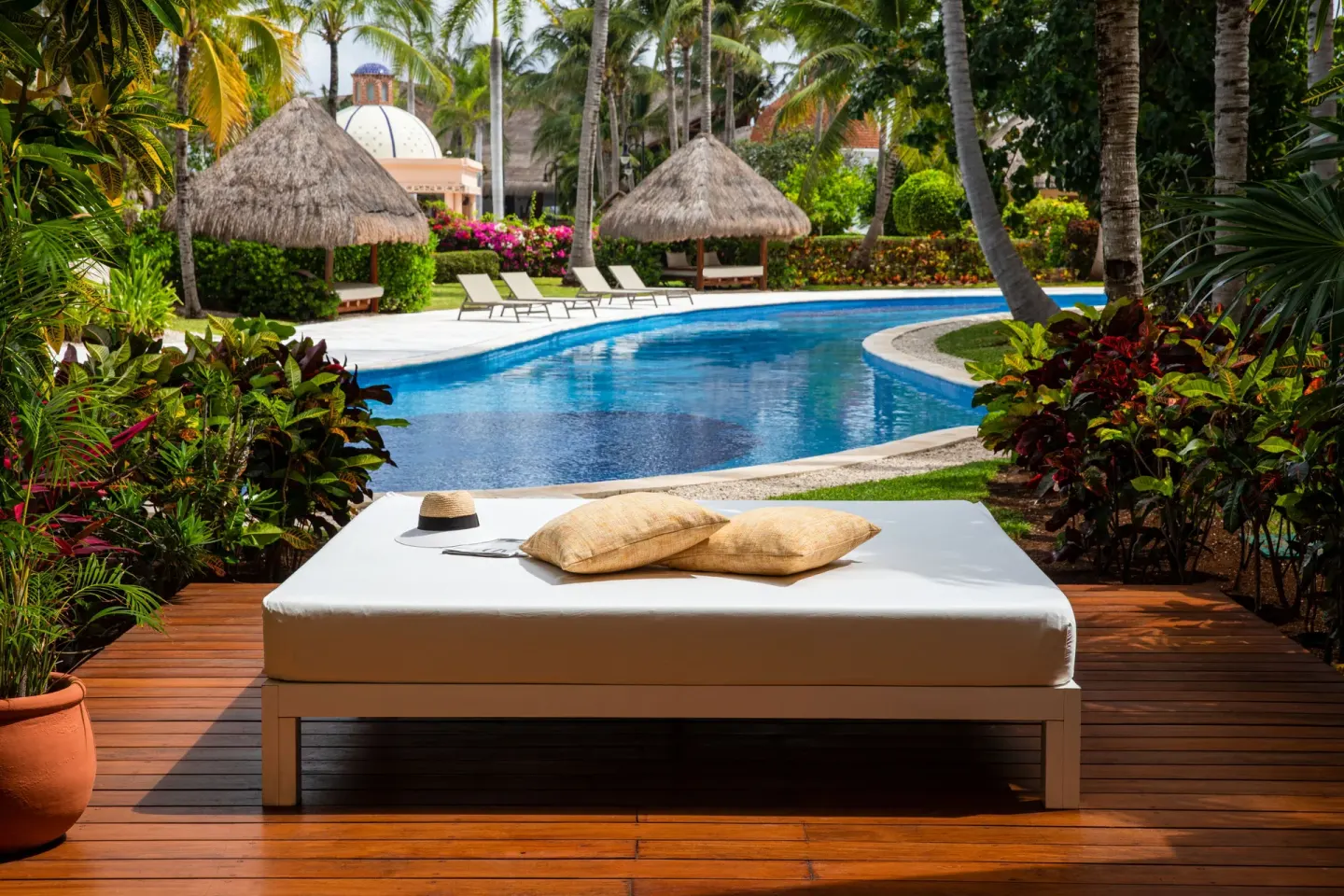 Poolside daybed on a swim-up suite terrace at Excellence Riviera Cancun.
