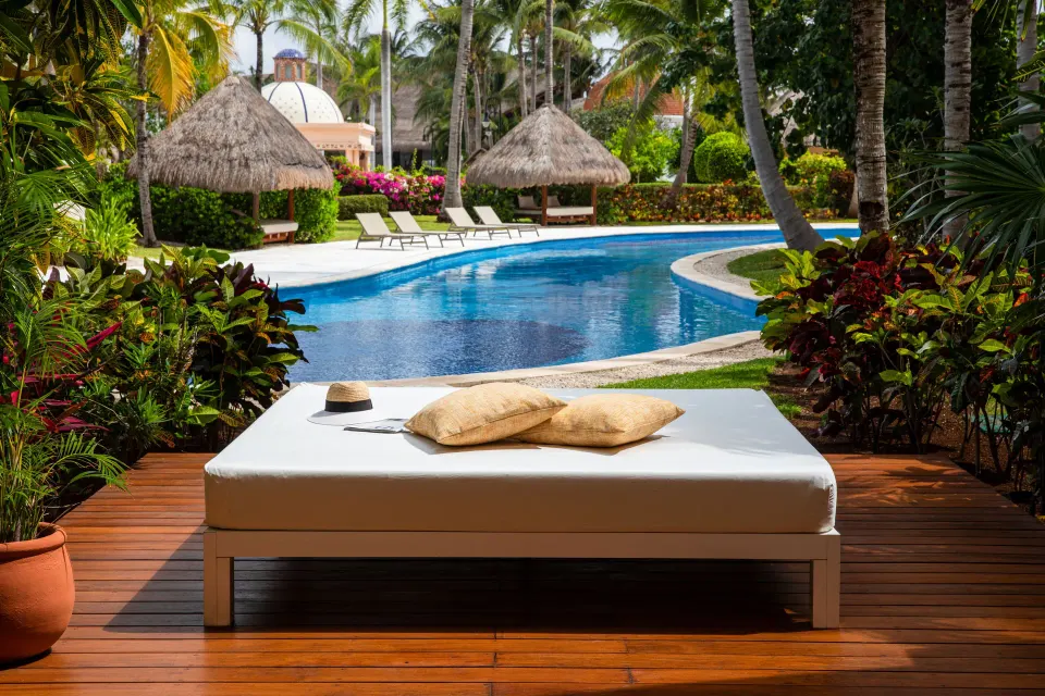 Poolside daybed on a swim-up suite terrace at Excellence Riviera Cancun.