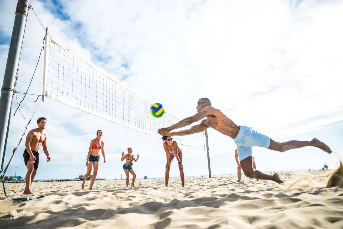 Beach volleyball players diving for the ball near Fairmont El San Juan.