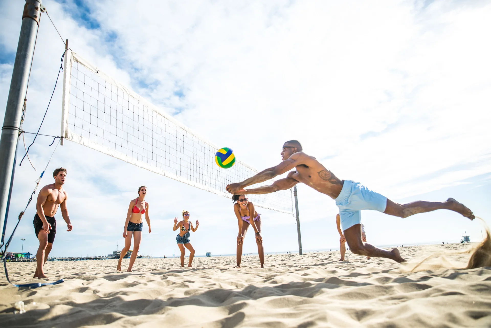 Beach volleyball players diving for the ball near Fairmont El San Juan.