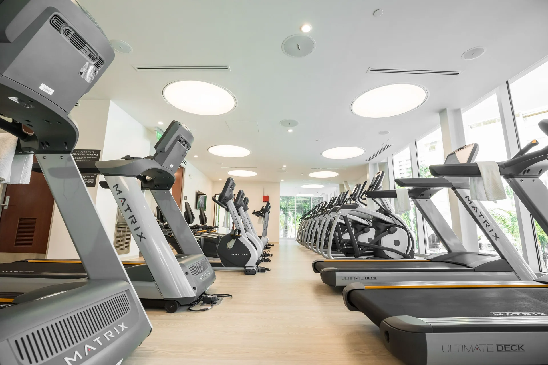 Rows of treadmills and cardio machines in the fitness center at Fairmont El San Juan.