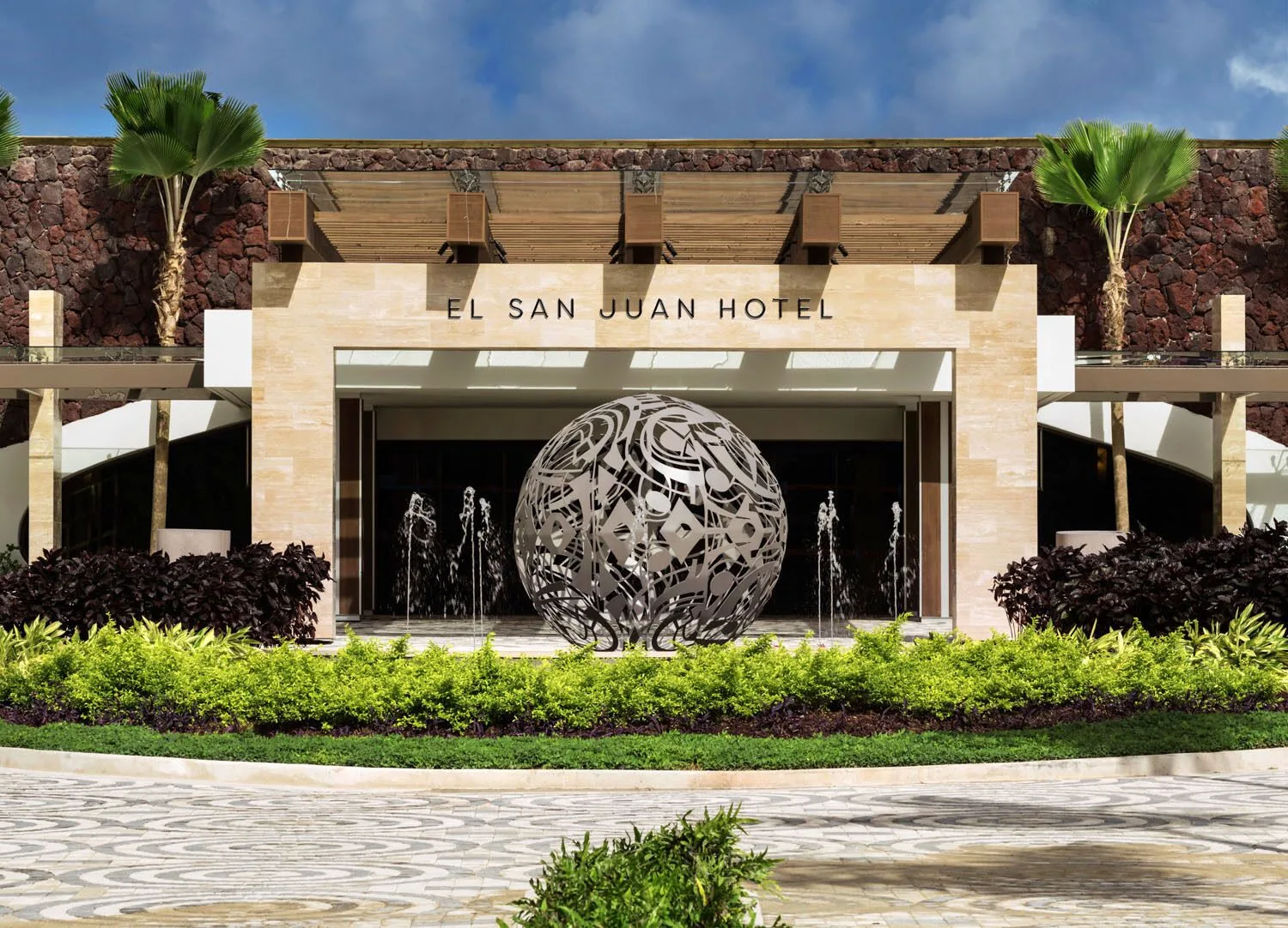 Main entrance with fountains and sculpture at Fairmont El San Juan.
