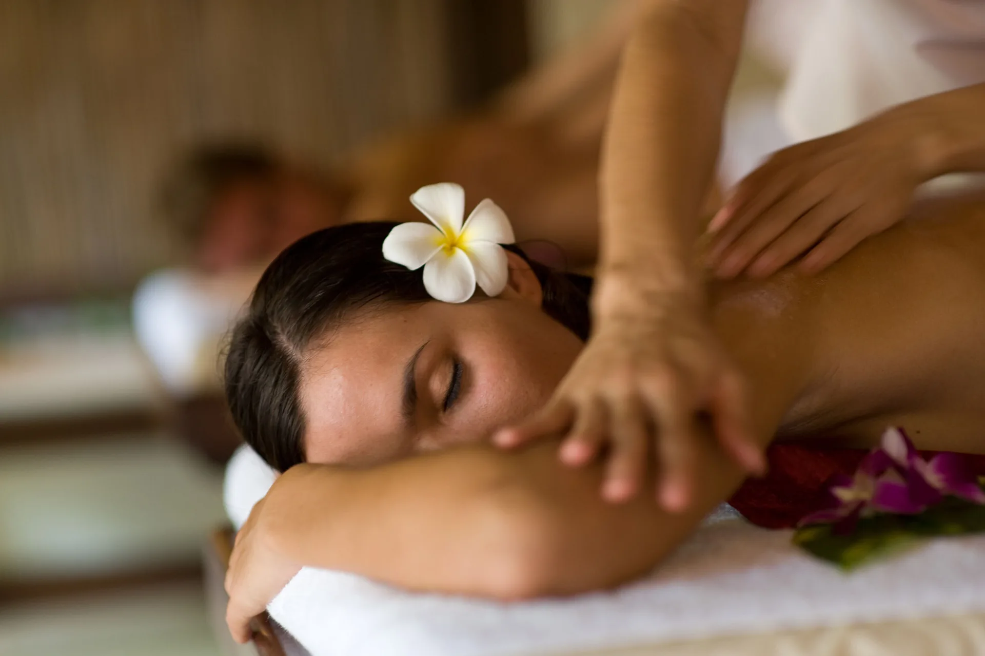 A guest receives a massage with a flower in her hair at Fairmont El San Juan.
