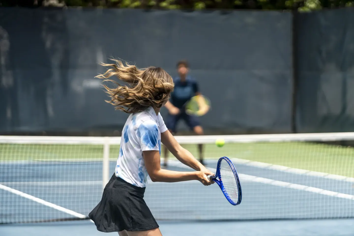 A guest swings a racket during a tennis match at Fairmont El San Juan.