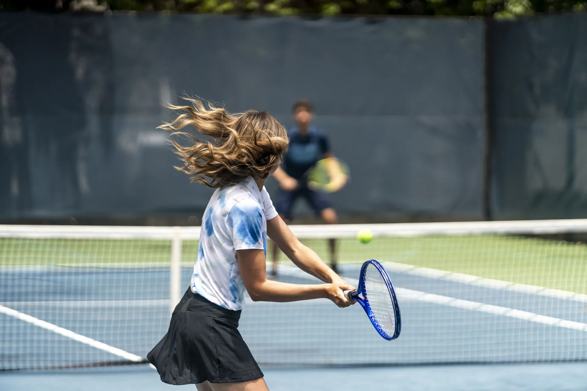 A guest swings a racket during a tennis match at Fairmont El San Juan.