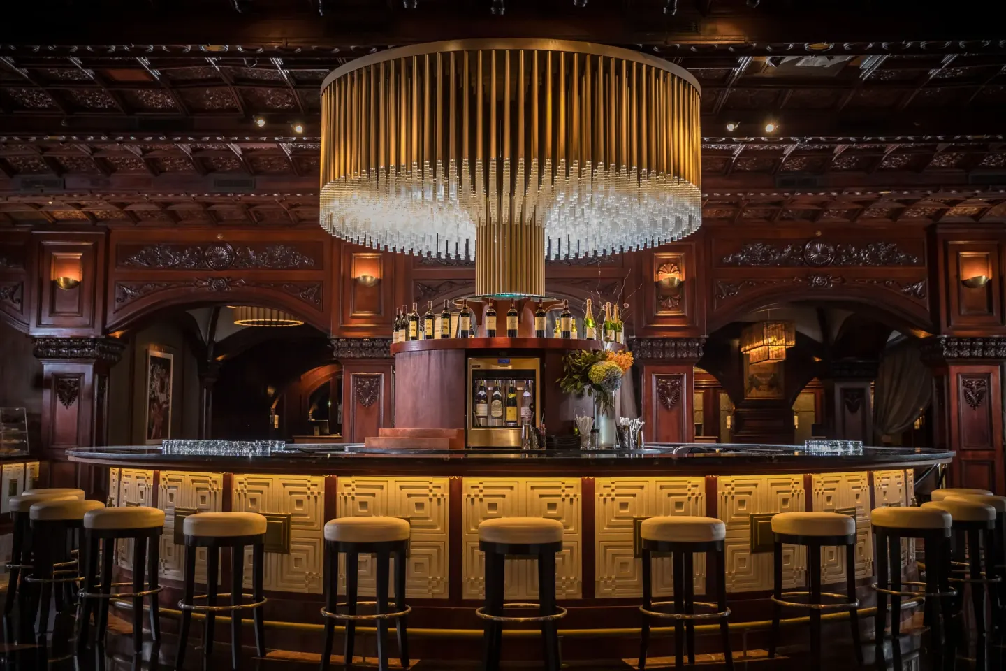 Circular lobby bar with chandelier and stools at Fairmont El San Juan.