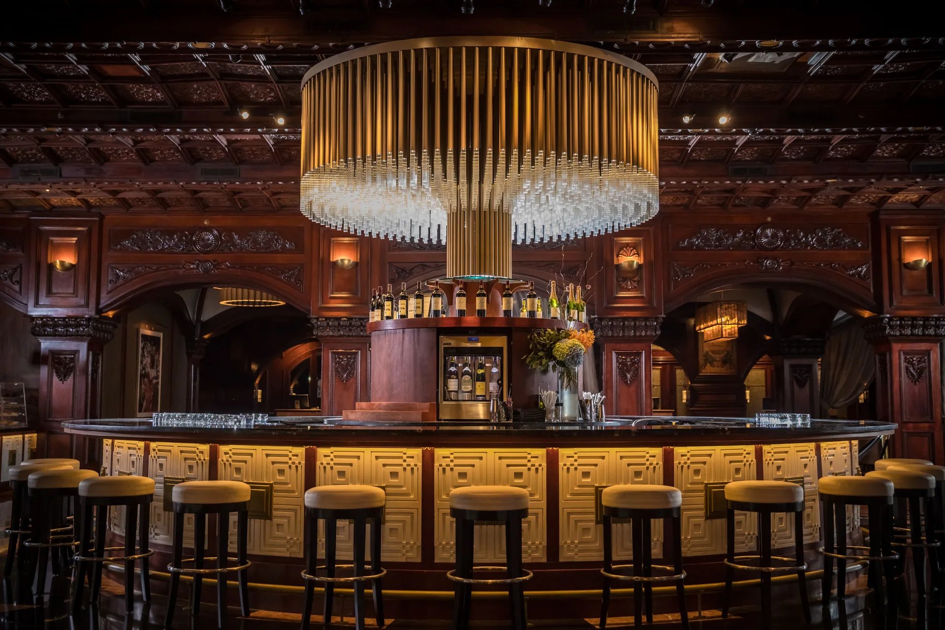 Circular lobby bar with chandelier and stools at Fairmont El San Juan.
