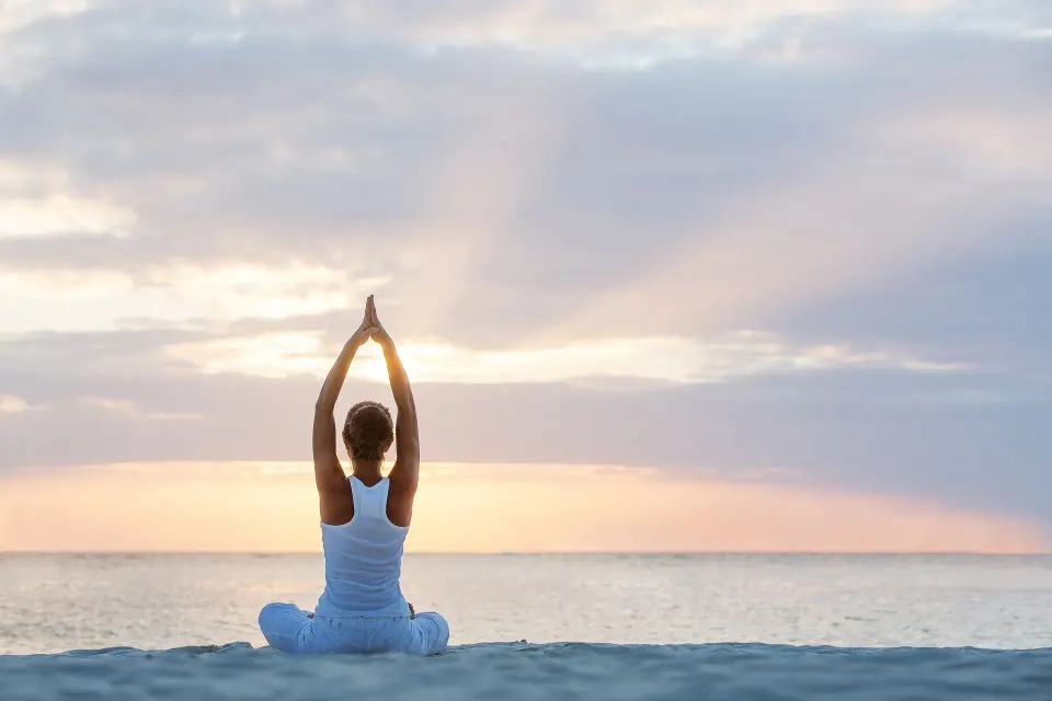 A person practices yoga on the beach at Fairmont El San Juan.