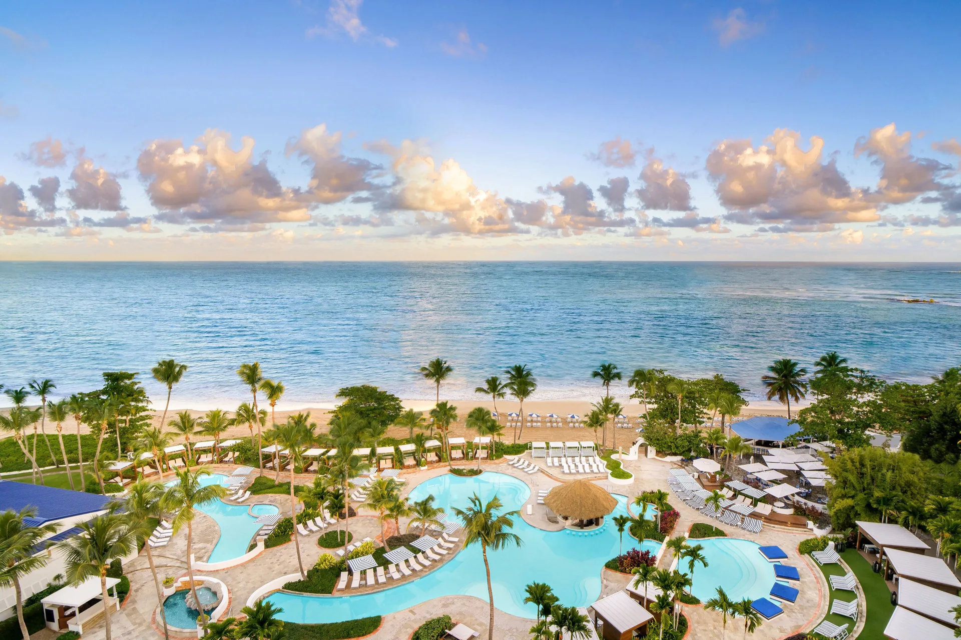 Pool, palm gardens and oceanfront beach at Fairmont El San Juan.