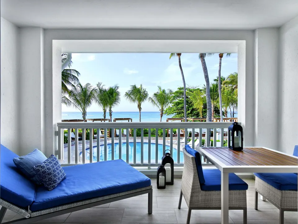 Furnished villa balcony with pool, palms and ocean view at Fairmont El San Juan.