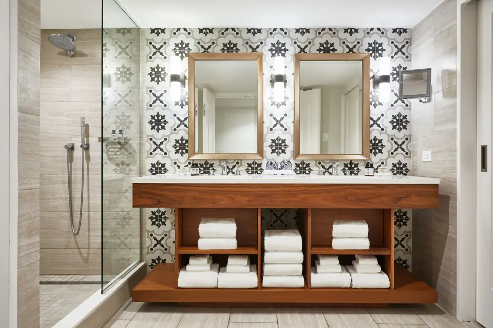 Villa bathroom with double vanity and glass shower at Fairmont El San Juan.