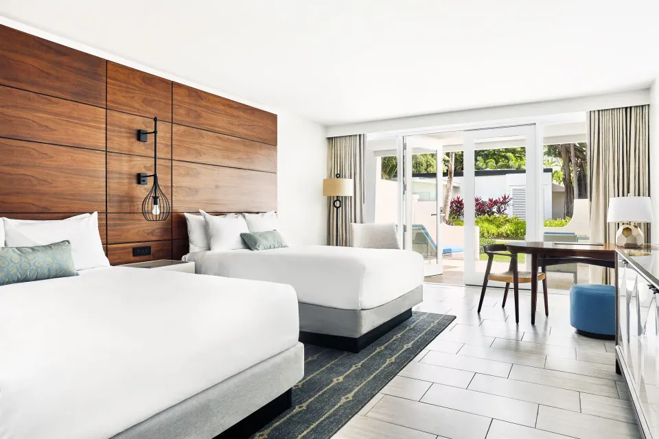 Villa room with two beds and poolside patio at Fairmont El San Juan.