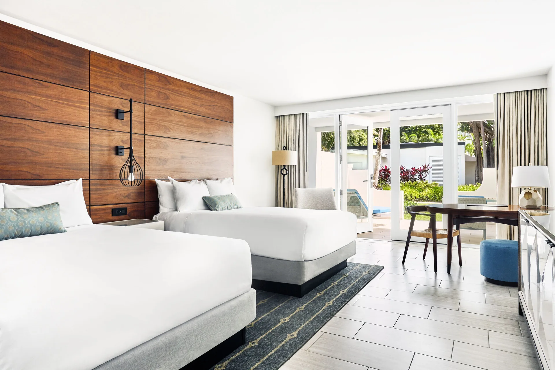 Villa room with two beds and poolside patio at Fairmont El San Juan.