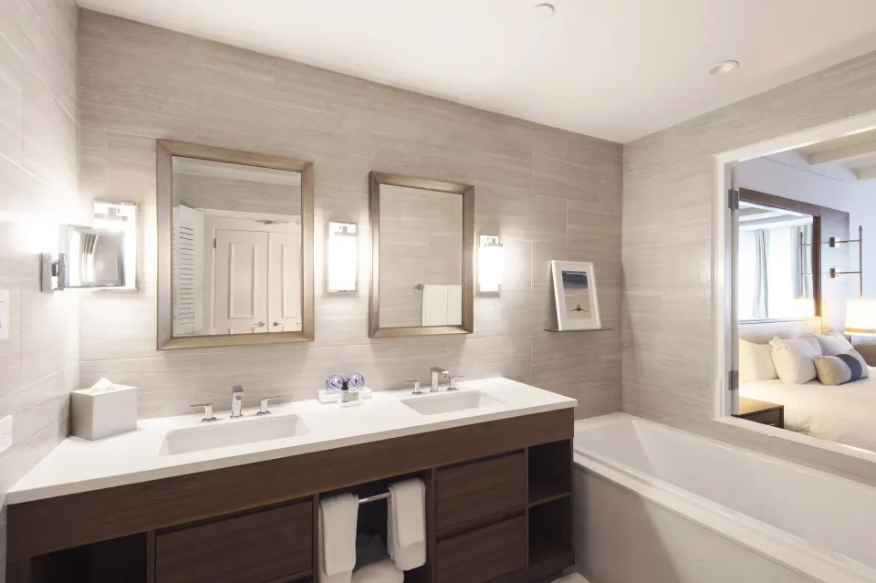 Villa bathroom at Fairmont El San Juan with double vanity, mirrors, and bathtub.