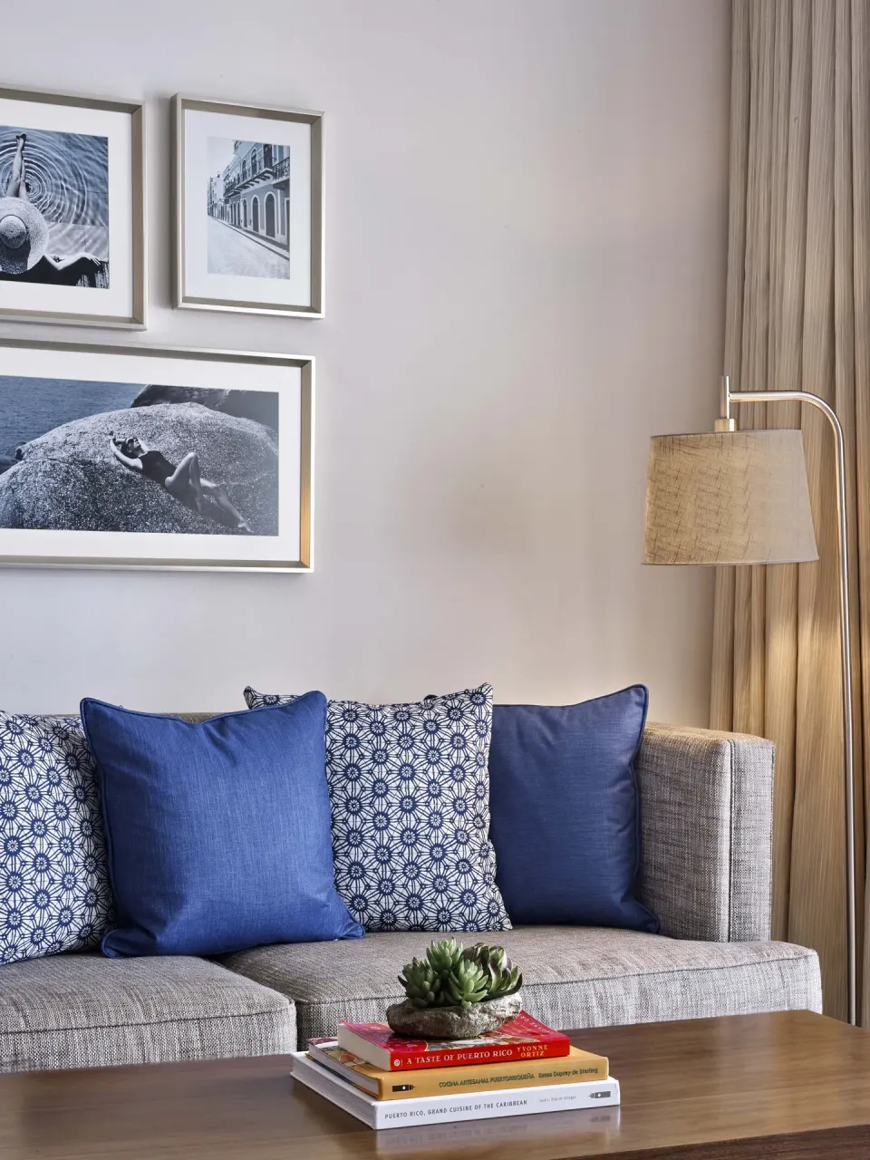 Gray sofa with blue pillows in a villa room sitting area at Fairmont El San Juan.