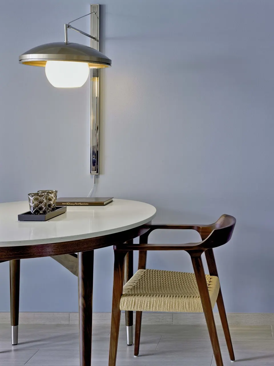 Round work table with chair and wall lamp in a villa room at Fairmont El San Juan.