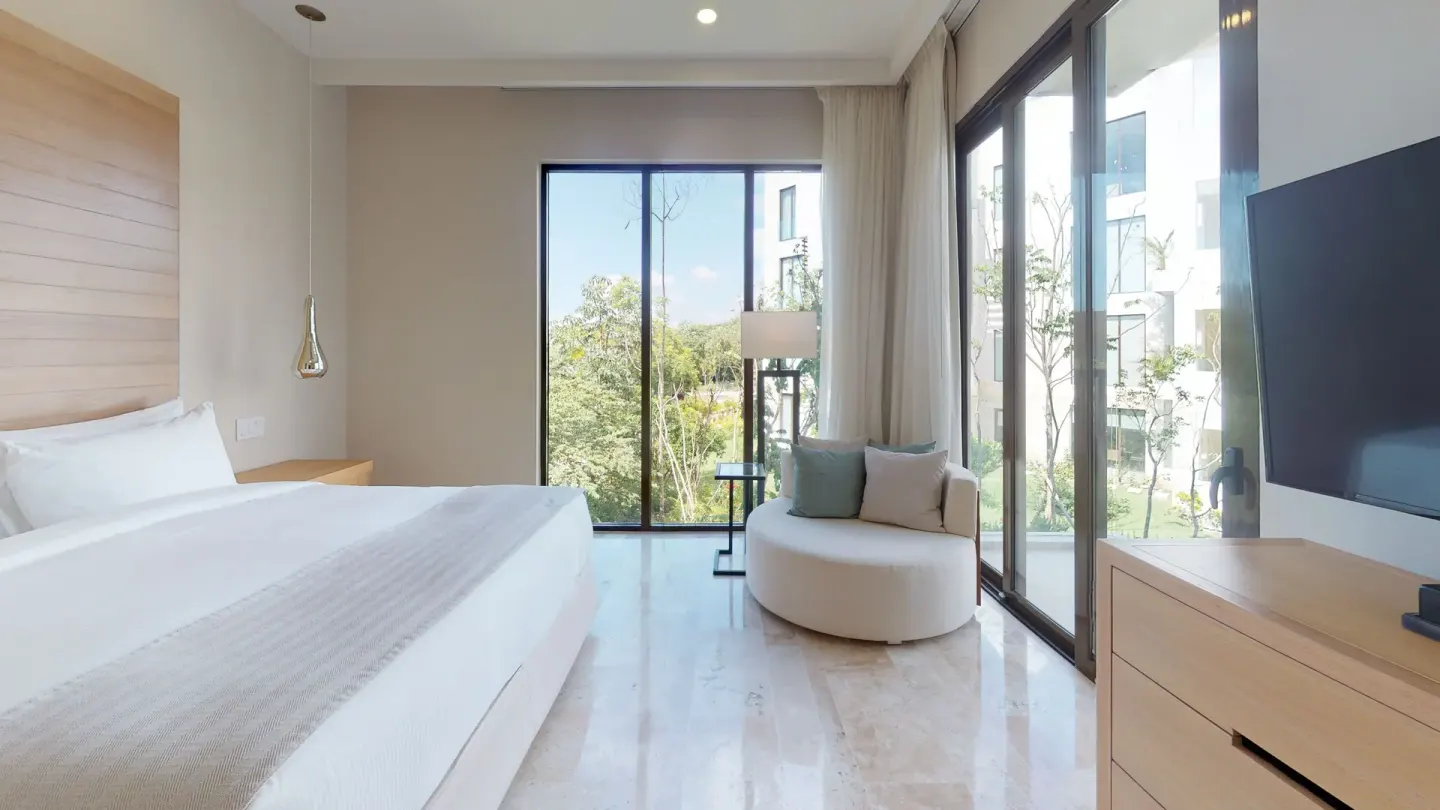 King bedroom with corner windows at Fairmont Heritage Place Mayakoba.