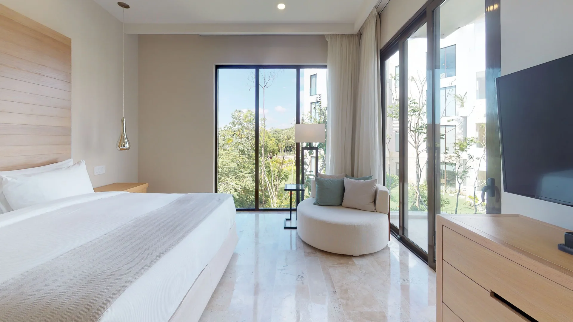 King bedroom with corner windows at Fairmont Heritage Place Mayakoba.