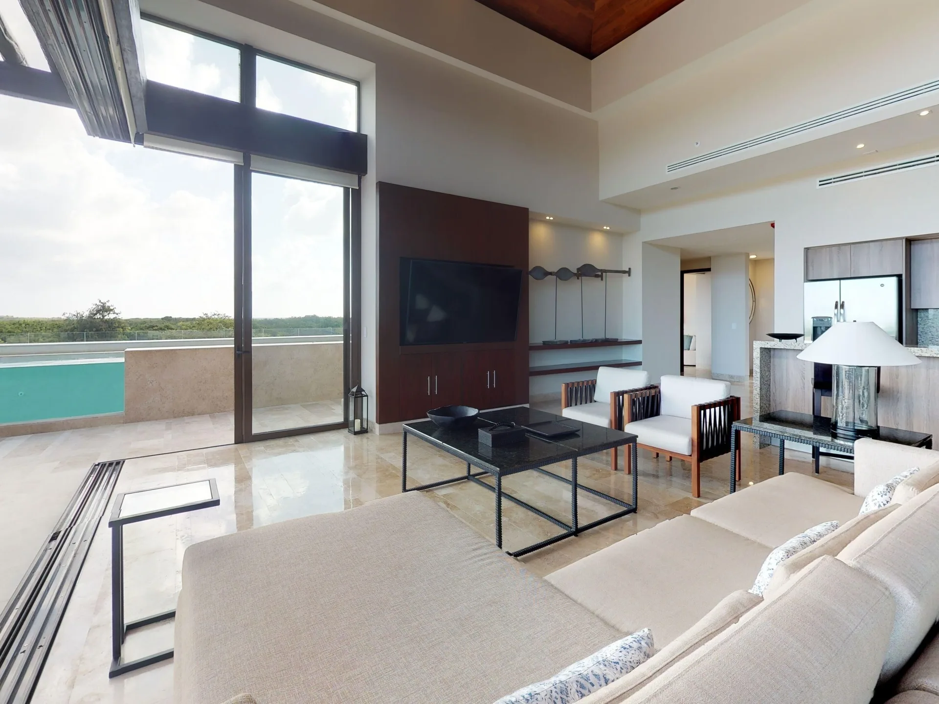 Living room with balcony pool view at Fairmont Heritage Place Mayakoba.