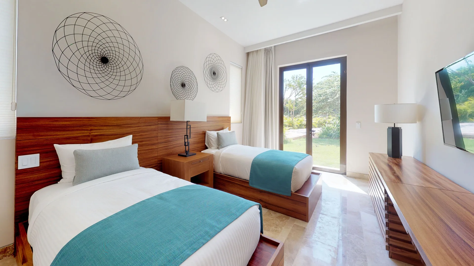 Twin-bed guest room with wall TV and garden doors at Fairmont Heritage Place Mayakoba.