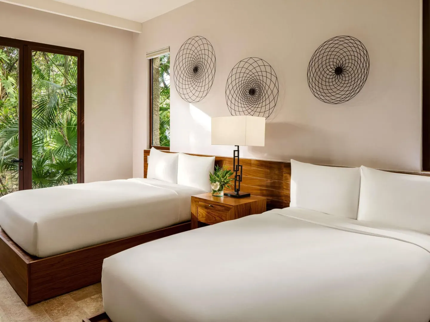 Two-bed garden villa bedroom with wood headboards at Fairmont Heritage Place Mayakoba.