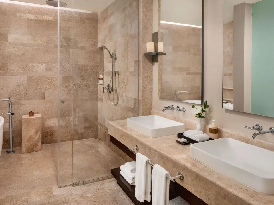 Villa bathroom with double sinks and glass shower at Fairmont Heritage Place Mayakoba.