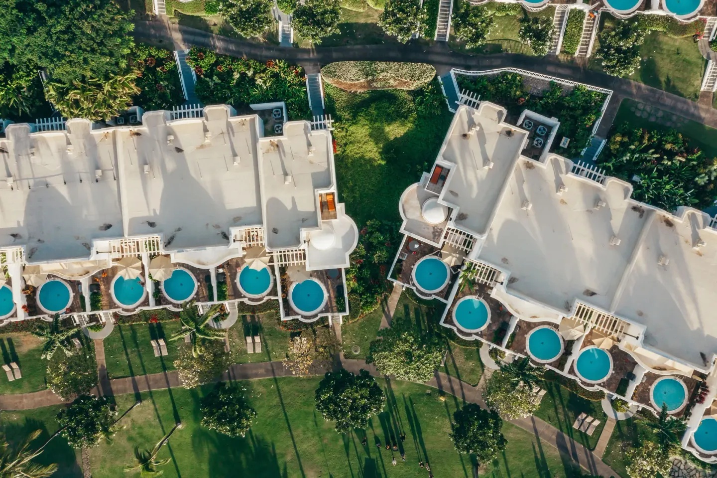 Aerial view of resort rooftops, lawns, paths, and plunge pools at Fairmont Kea Lani Maui.