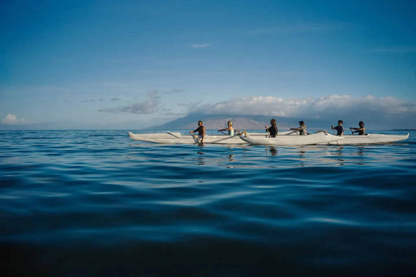 Group paddling an outrigger canoe offshore at Fairmont Kea Lani Maui.