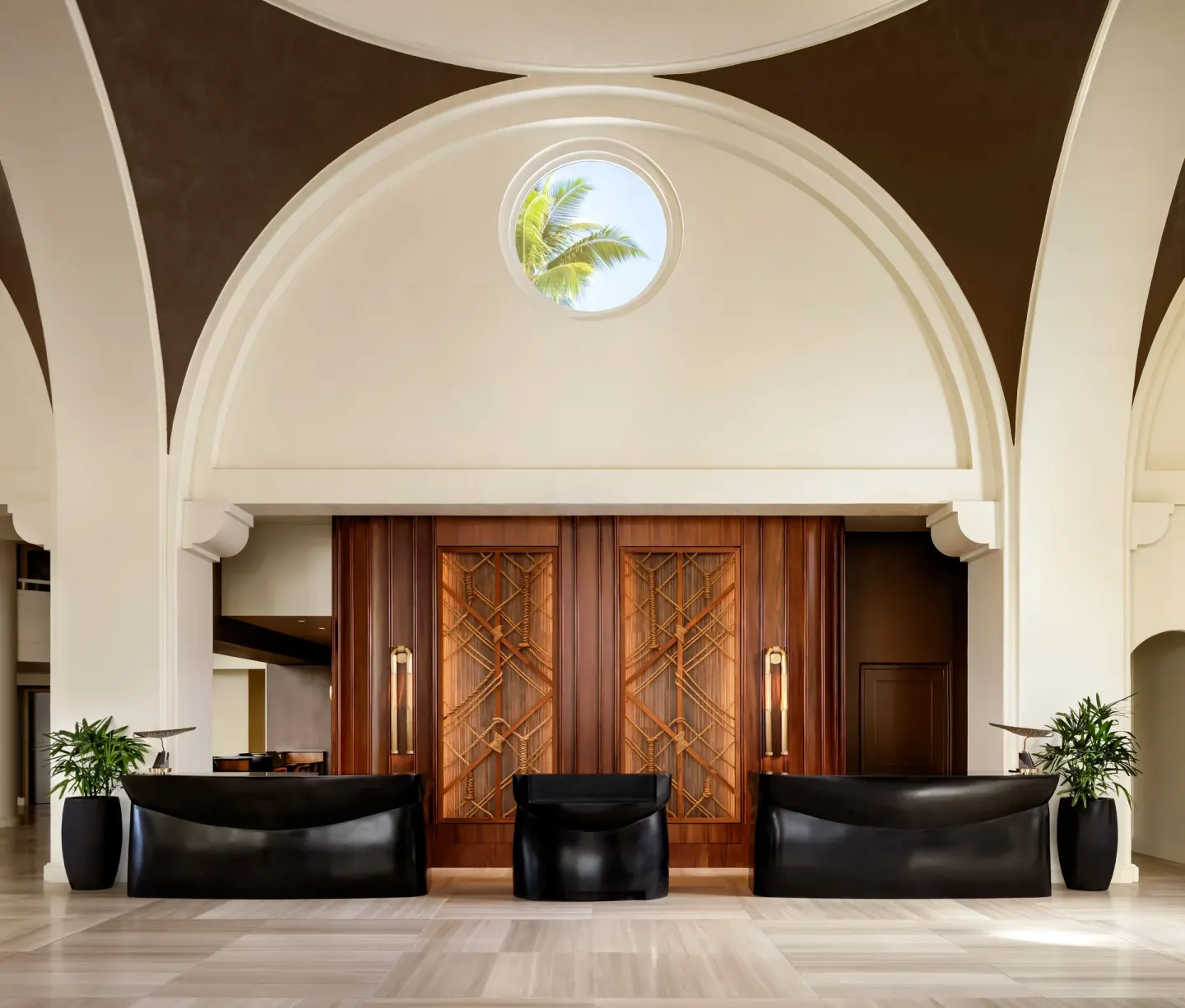 Lobby reception desks beneath a high arched ceiling at Fairmont Kea Lani Maui.