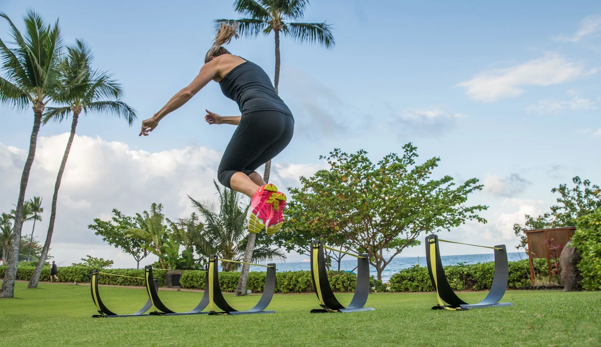 A person jumps over outdoor fitness obstacles at Fairmont Kea Lani Maui.