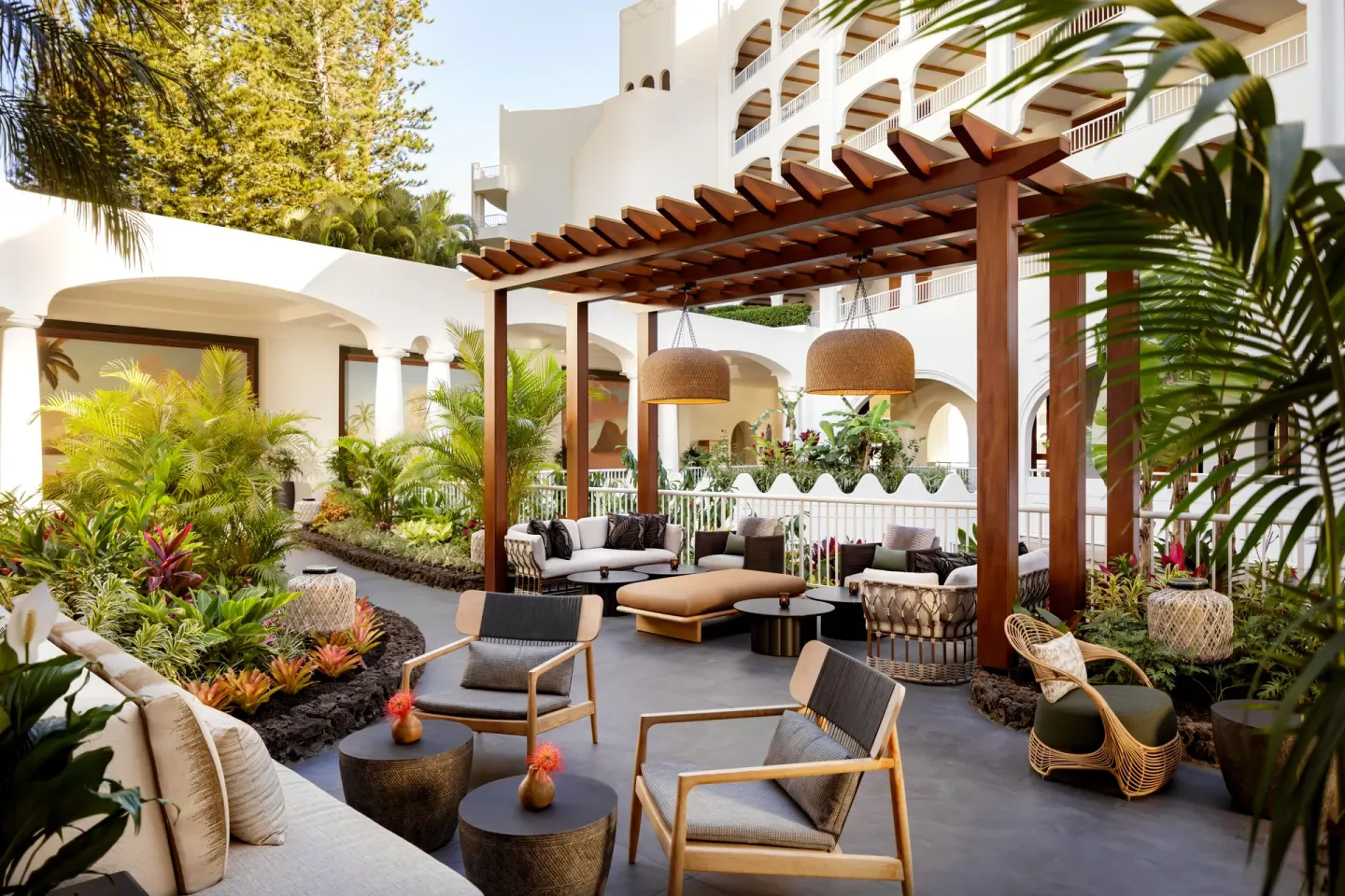 Outdoor lounge seating under a wood pergola at Fairmont Kea Lani Maui.