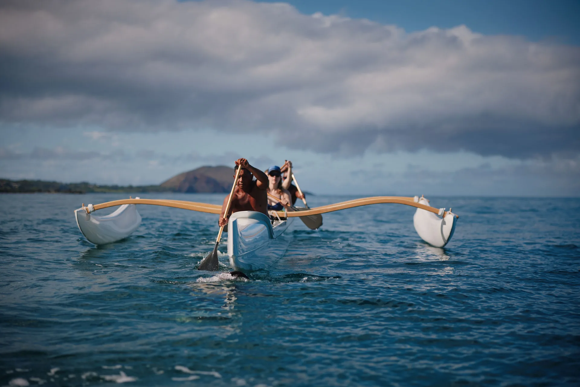Two guests paddling an outrigger canoe off Fairmont Kea Lani Maui.