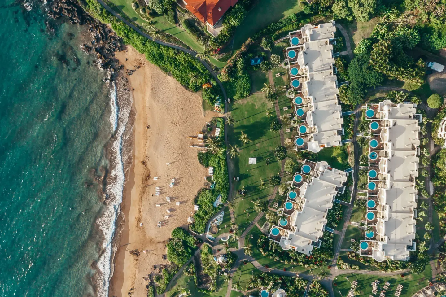 Overhead view of the beach, ocean, lawns, and resort villas at Fairmont Kea Lani Maui.
