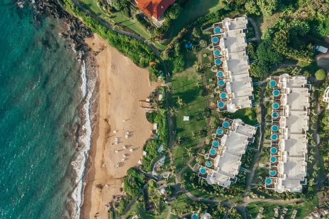 Overhead view of the beach, ocean, lawns, and resort villas at Fairmont Kea Lani Maui.