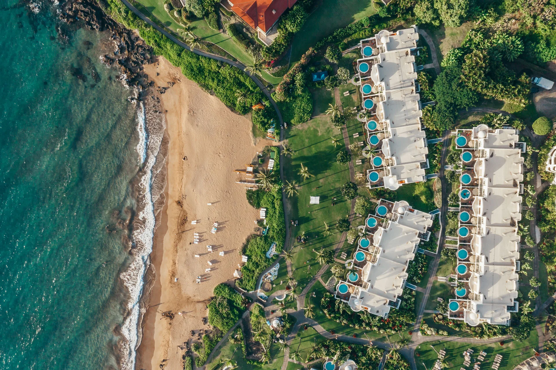 Overhead view of the beach, ocean, lawns, and resort villas at Fairmont Kea Lani Maui.
