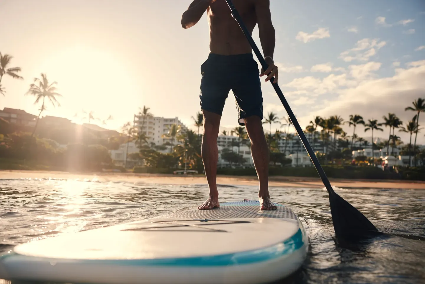Stand-up paddleboarder near the beach at Fairmont Kea Lani Maui.