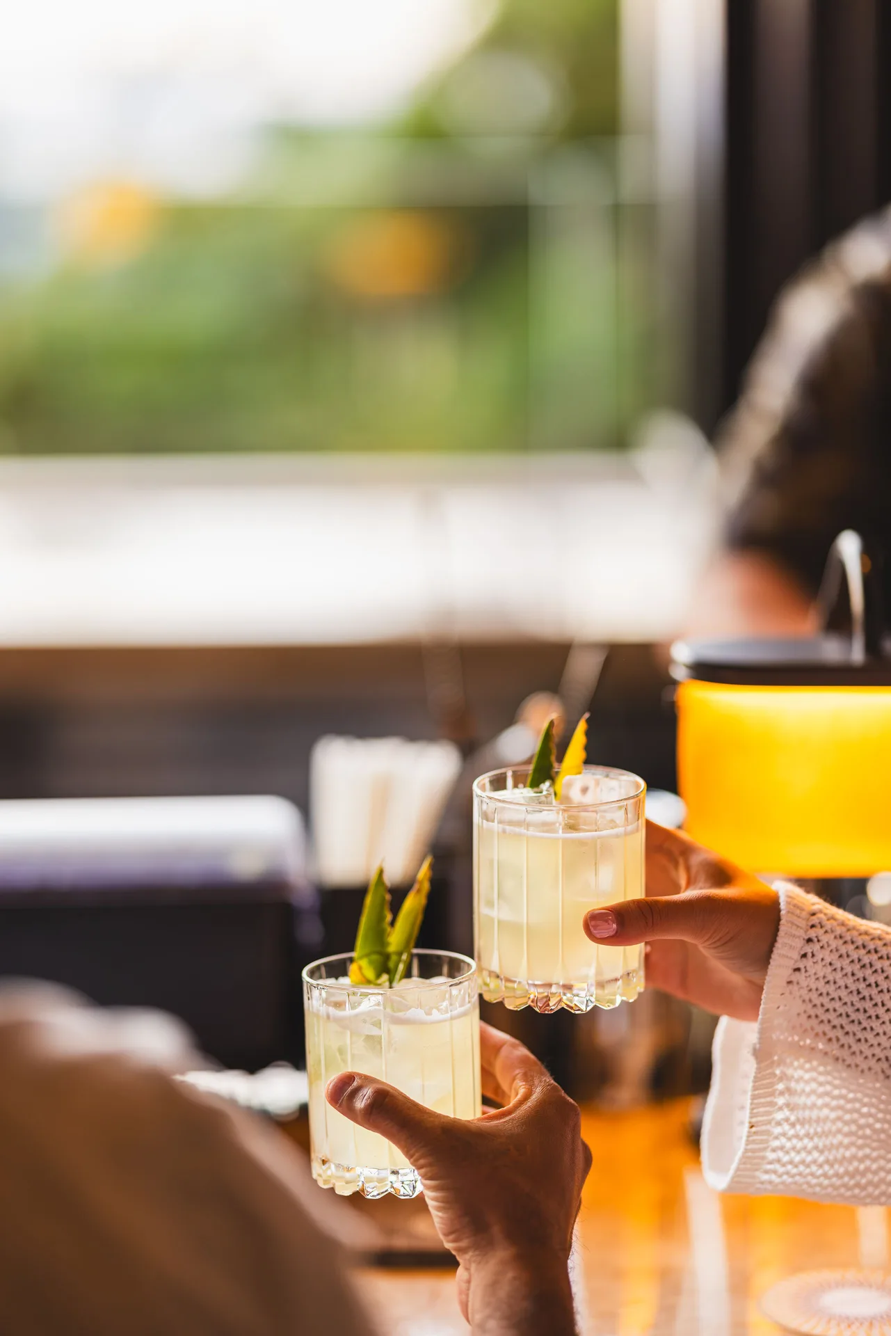 Two cocktails being raised in a toast at Fairmont Kea Lani Maui.